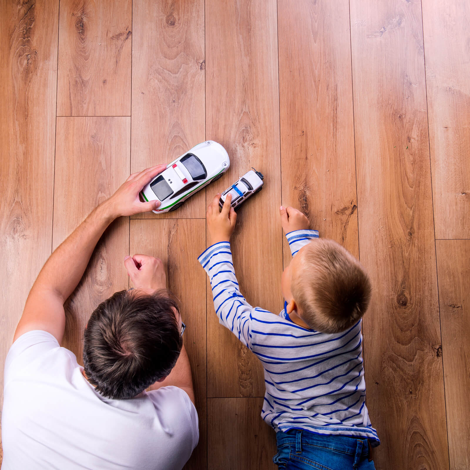 Dad child playing on Hardwood | Flooring By Design NC