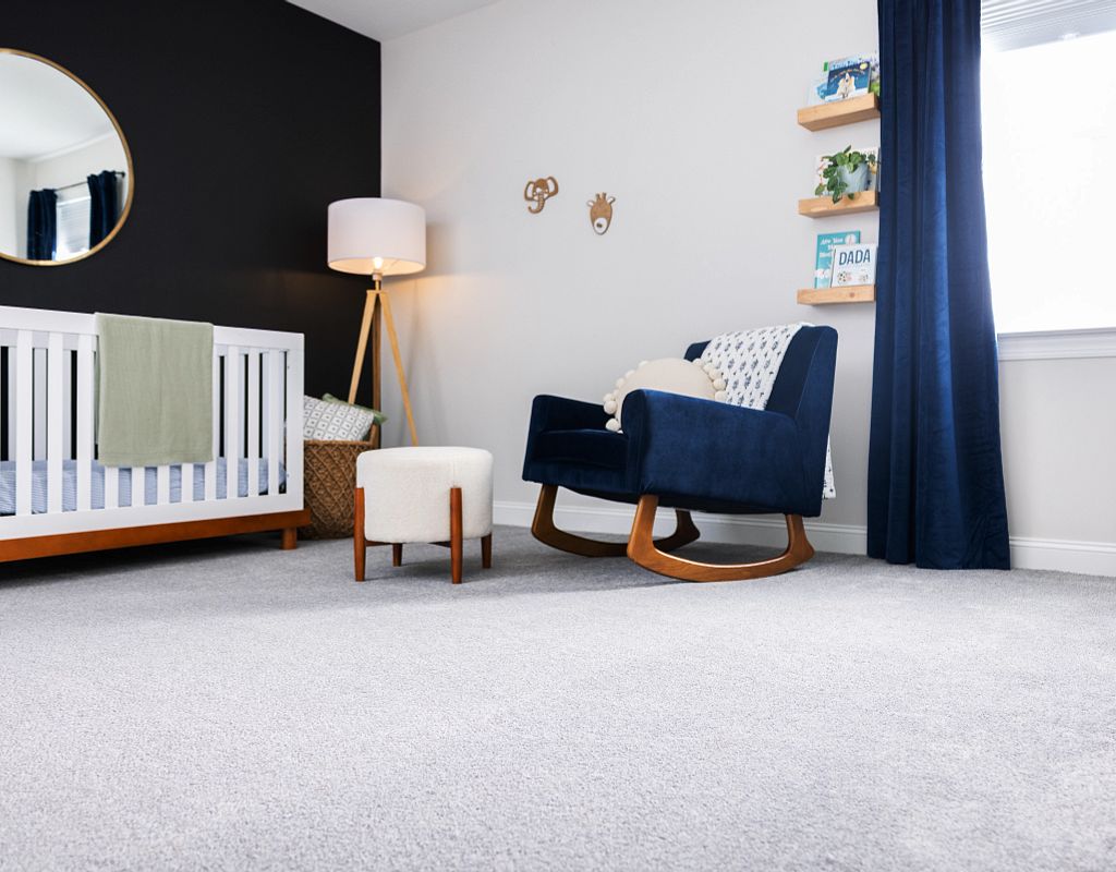 Blue chair on carpet floor | Flooring By Design NC